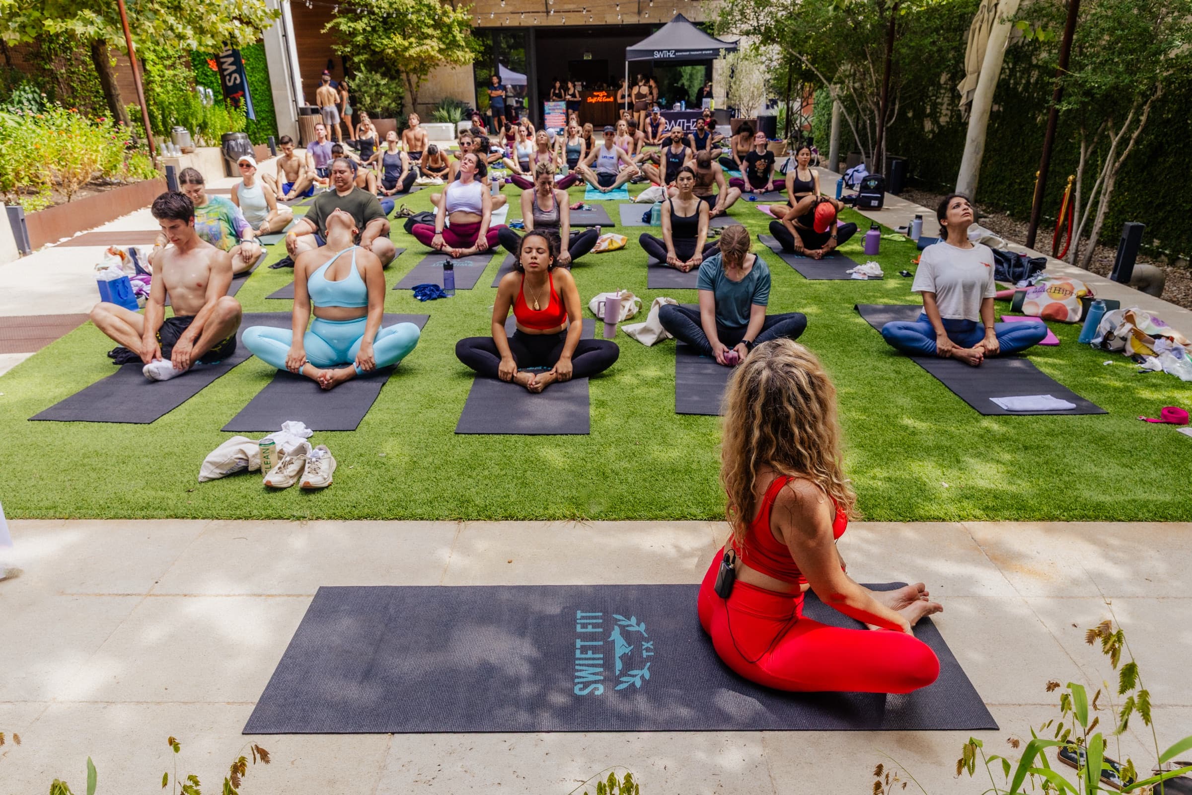 Liz leading an outdoor courtyard yoga class